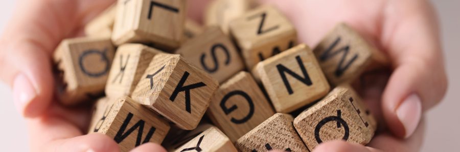 Full set of wooden cubes with letters on the palms, close-up. Alphabetical training, set of fonts, writing